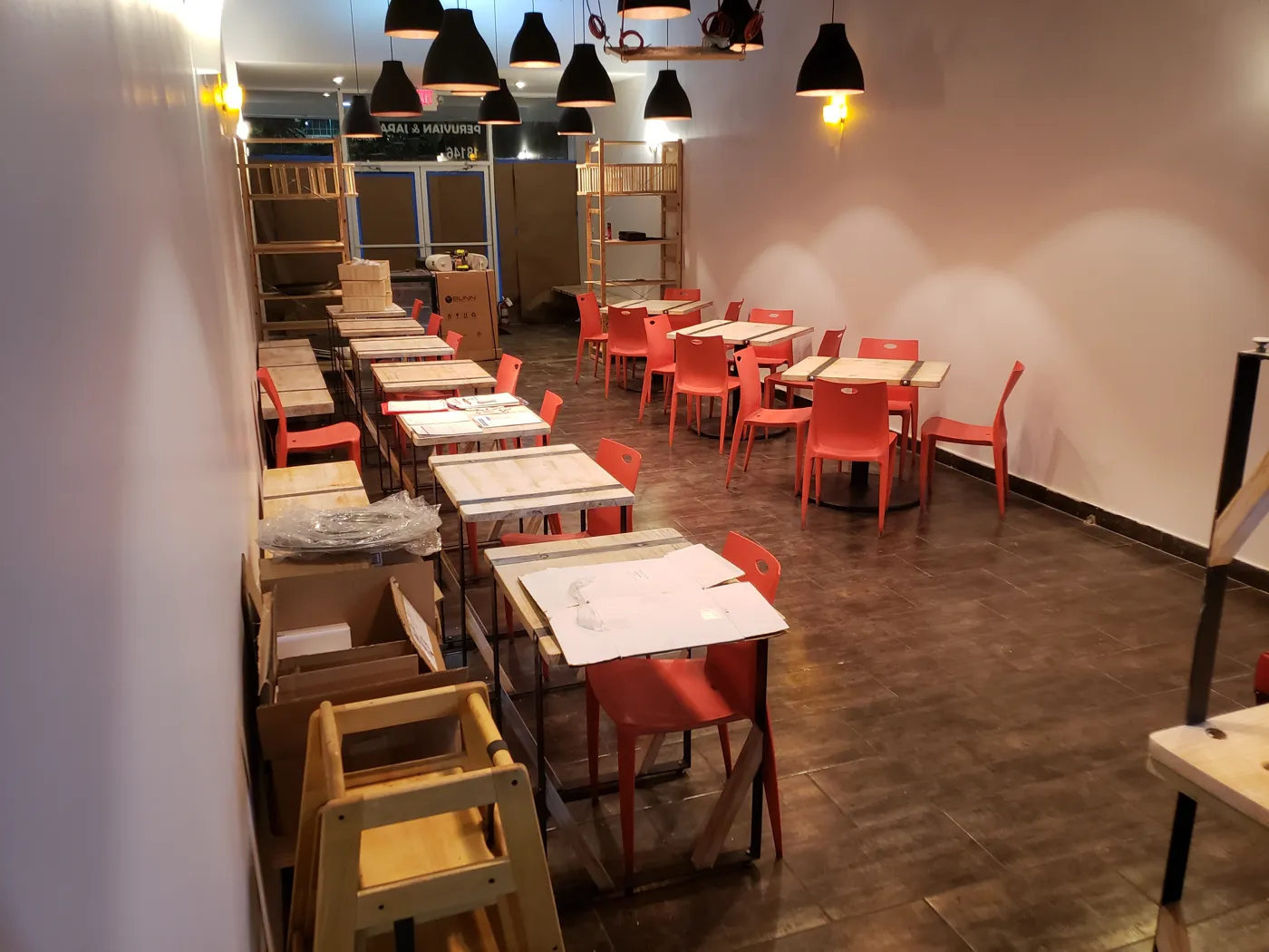 The Lentrecote dining room in Sunny Isles Beach during the 2018 build-out, with red chairs and new tables
