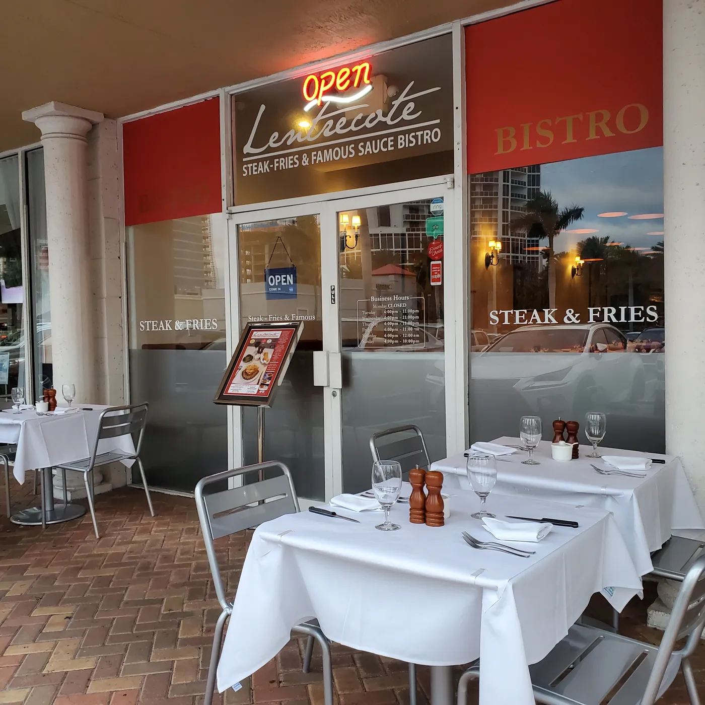 The Lentrecote storefront at 18146 Collins Ave, Sunny Isles Beach, with outdoor tables set in white linen